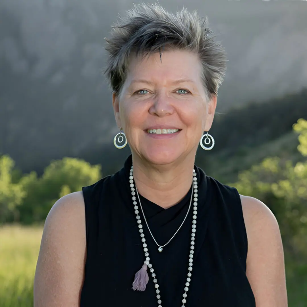 A woman with short hair and wearing earrings.